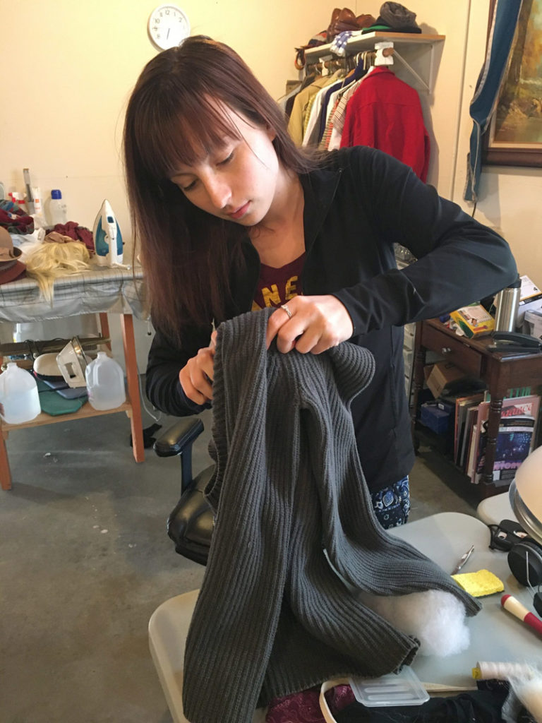 Alicia Ehleringer distressing a costume for The Fox